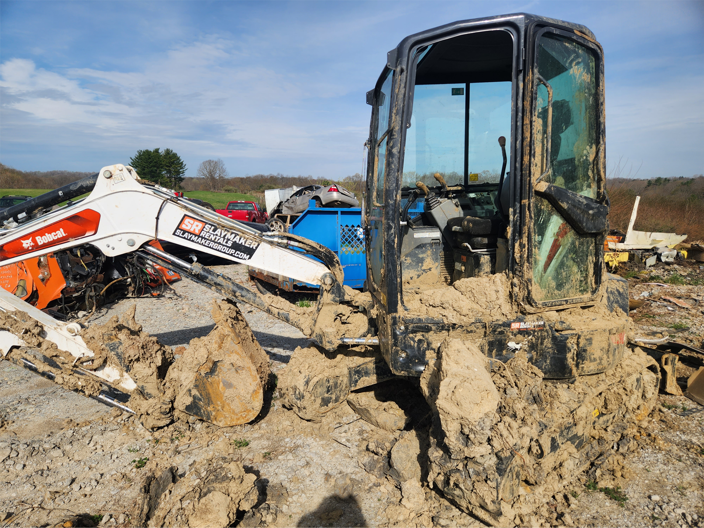 Bobcat caked in dried mud from use